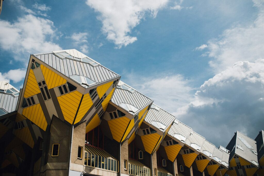 Tilted yellow cube houses by Piet Blom in Rotterdam against a blue sky